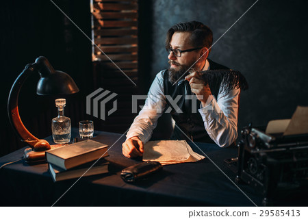Bearded writer in glasses smoking a pipe Bearded writer in glasses smoking a pipe 29585413