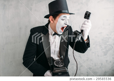 Pantomime actor performing with retro telephone 29585536
