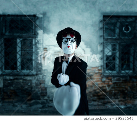 Pantomime actor in glasses shows boxer 29585545