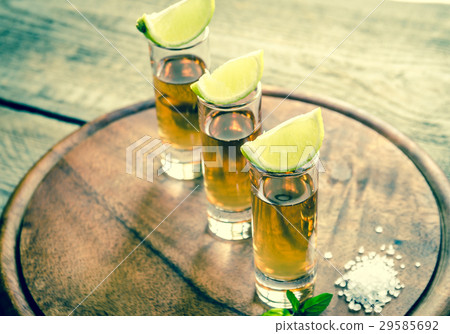 Glasses of tequila on the wooden board Glasses of tequila on the wooden board 29585692