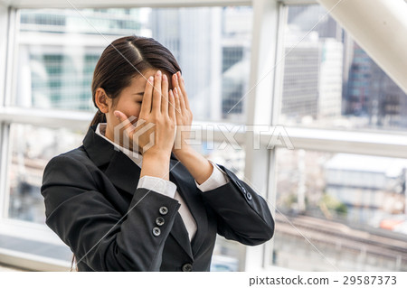 A woman hiding her face A woman hiding her face 29587373