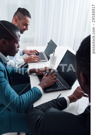 IT manager makes training for employees in office 29588917