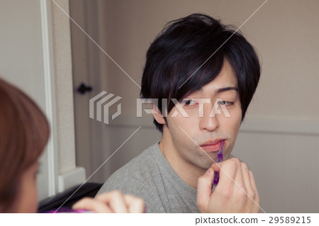 A couple in their twenties brushing their teeth in a room 29589215