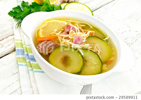 Soup with zucchini and noodles on light board Soup with zucchini and noodles on light board 29589911