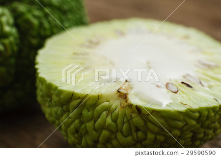 Cut exotic green Adam's apple fruit closeup 29590590