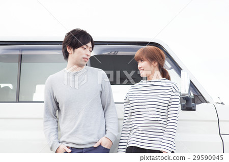 20's couple talking in front of the car 29590945