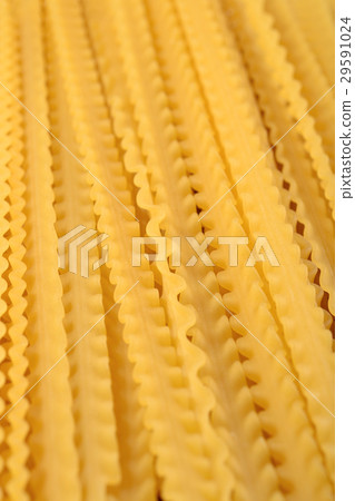 Uncooked Italian pasta mafaldine close up 29591024