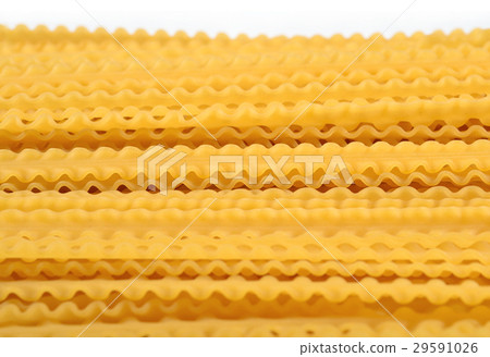 Uncooked Italian pasta mafaldine on a white 29591026