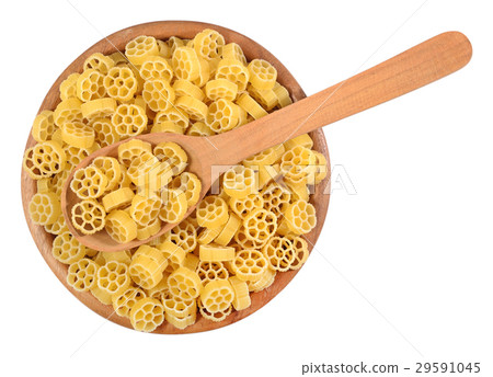 Uncooked italian pasta rotelle in a wooden bowl 29591045