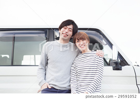 20's couple talking in front of the car 20's couple talking in front of the car 29591052