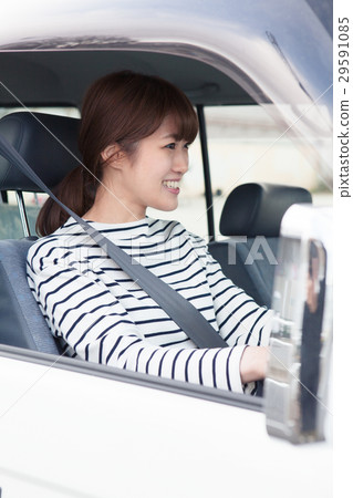 Women in their twenties driving by car Women in their twenties driving by car 29591085
