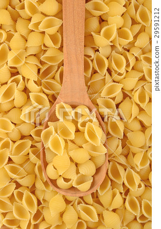 Uncooked italian pasta shells in a spoon 29591212