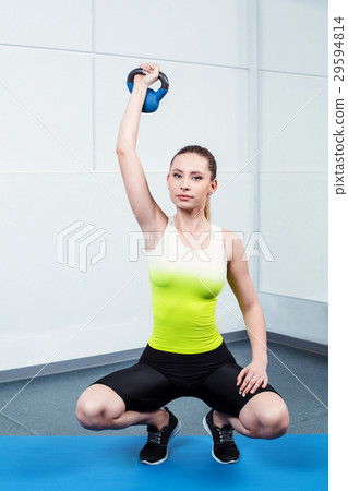 Young woman training at fitness club 29594814