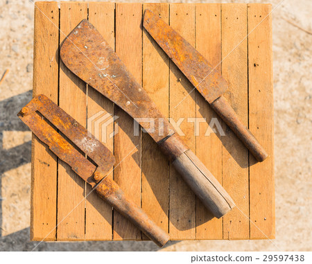 Rusty knifes on wooden tiles, farmer equipment 29597438