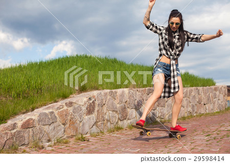 The woman does a trick with skate The woman does a trick with skate 29598414