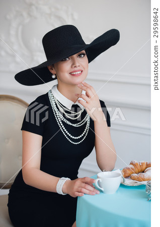 Woman in hat, much like the famous actress Woman in hat, much like the famous actress 29598642