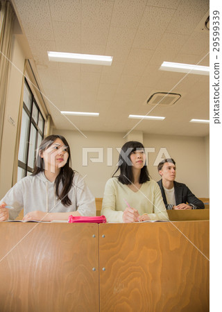 Female students receiving university lecture Female students receiving university lecture 29599339