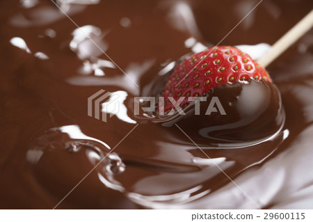 dipping strawberry into dark premium chocolate dipping strawberry into dark premium chocolate 29600115