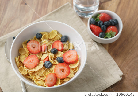 dry corn flakes with berries in bowl on table dry corn flakes with berries in bowl on table 29600143