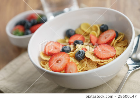 dry corn flakes with berries in bowl on table dry corn flakes with berries in bowl on table 29600147