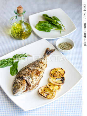 Grilled dorada fish with lemon and spinach Grilled dorada fish with lemon and spinach 29601068