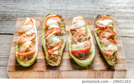 Stuffed zucchini on the wooden board Stuffed zucchini on the wooden board 29601163