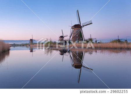 Windmills and blue sky at sunrise in Kinderdijk Windmills and blue sky at sunrise in Kinderdijk 29602255