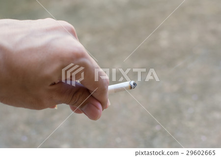 man hand smoking a cigarette.. man hand smoking a cigarette.. 29602665