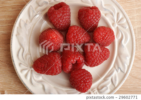 fresh red raspberries on a plate top view fresh red raspberries on a plate top view 29602771