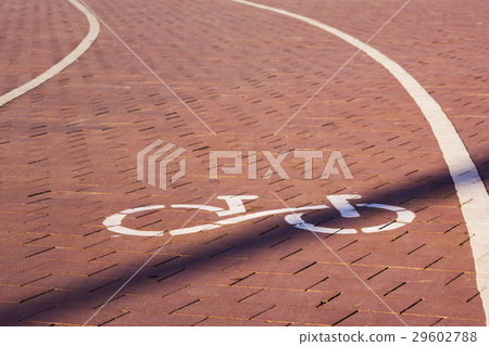 Bike path sign. Path paved with cobblestones. 29602788