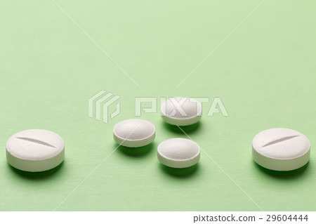 Round white pills on colorful background Round white pills on colorful background 29604444