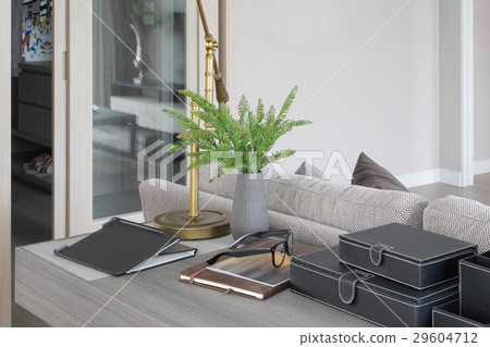 Brass lamp on wooden working table in living room Brass lamp on wooden working table in living room 29604712