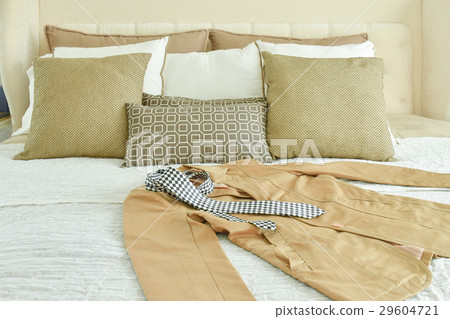 Yellow suit and tie settng on bed Yellow suit and tie settng on bed 29604721