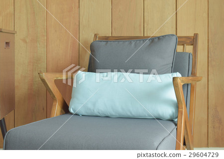 Retro armchair with wooden wall in background 29604729