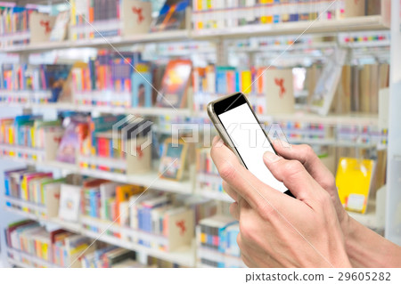 Hands using smartphone in library 29605282