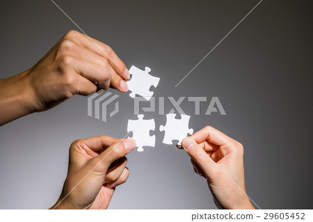 Hand with jigsaw puzzle 29605452