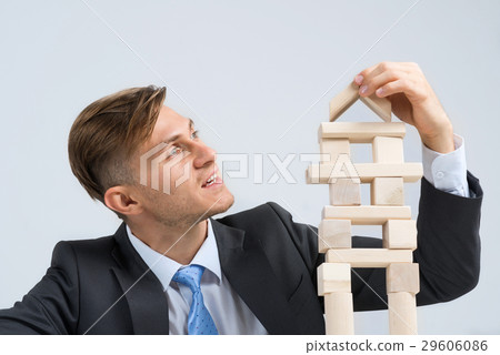 Businessman making tower Businessman making tower 29606086