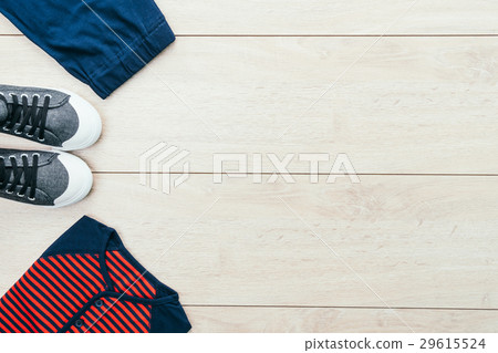 T-shirt with pants and shoes on wooden background T-shirt with pants and shoes on wooden background 29615524