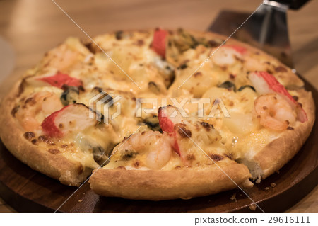 Delicious seafood pizza on a wooden textured table 29616111
