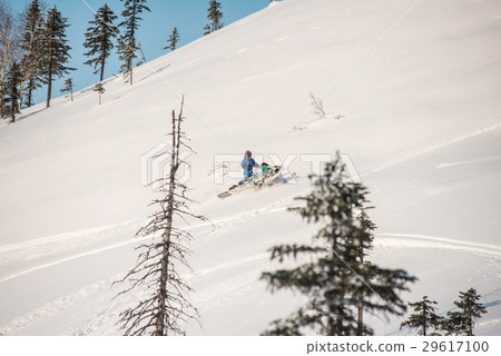 Rider on the snowmobile in the mountains Rider on the snowmobile in the mountains 29617100