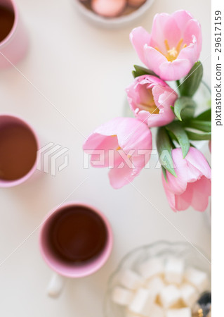 Spring background. Sweets and tea on a table with Spring background. Sweets and tea on a table with 29617159