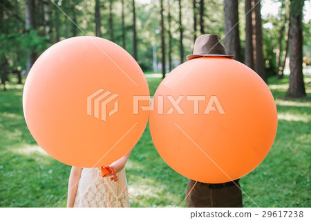 newlyweds with orange balloons. the amusing photo newlyweds with orange balloons. the amusing photo 29617238