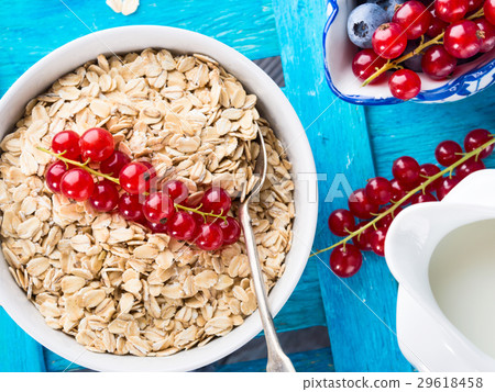 Rolled Oats and berries blue textured background Rolled Oats and berries blue textured background 29618458