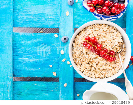 Rolled Oats and berries blue textured background Rolled Oats and berries blue textured background 29618459
