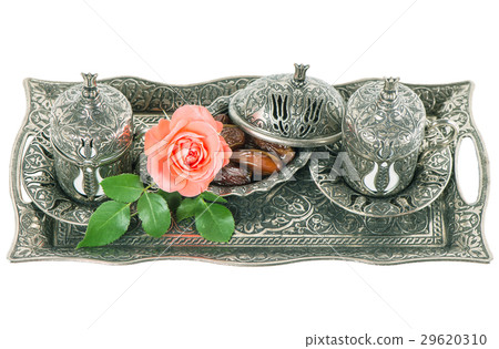Tea table setting withdates, mint leaves,  flower 29620310