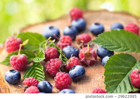 Blueberry and raspberry on wooden surface 29622085
