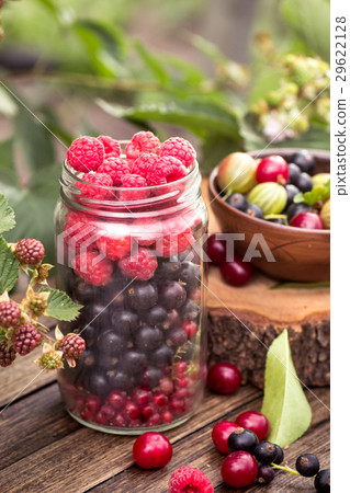 Glass jar of various berries 29622128
