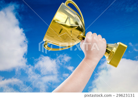 hand holding golden trophy 29623131