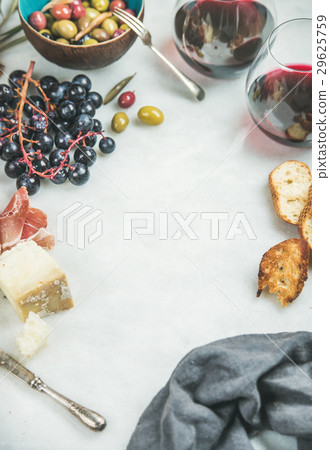 Red wine and snack set over grey marble background Red wine and snack set over grey marble background 29625759