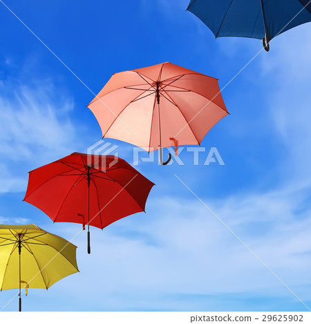 Colorful umbrellas flying into blue sky Colorful umbrellas flying into blue sky 29625902